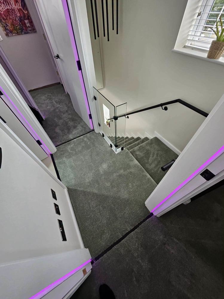 Grey landing carpet fitted around a glass balustrade, Sheffield