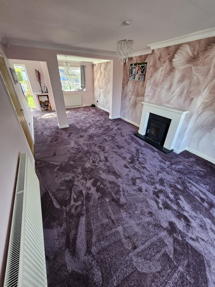 Purple lounge carpet fitted around a log burner, Sheffield